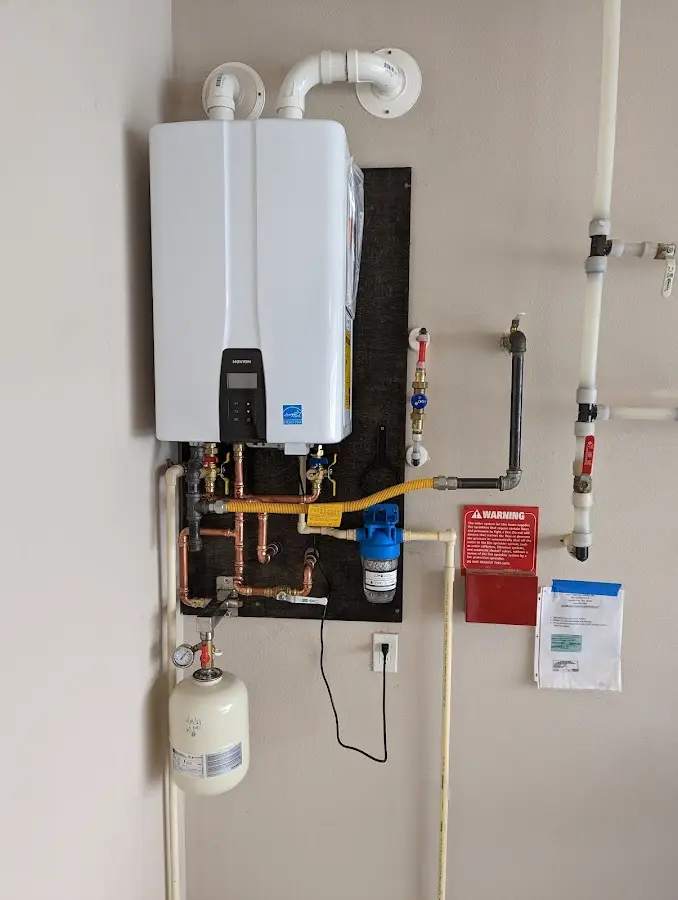 Professional plumber installing copper piping in a Littleton home